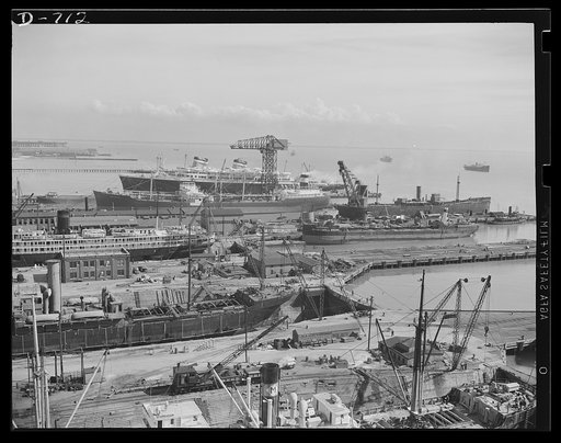 Newport News, Virginia. General view of the fitting and repair slips at Newport News, Virginia. The S.S. America can be seen in the background. The ship in the adjacent slip is a tanker