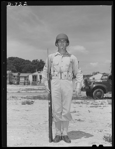 New Army helmet. Corporal French L. Vineyard, Company M, 12th Infantry, wearing a new Army helmet. Corporal Vineyard is wearing the combat pack and cartridge belt and is equipped with a Garand rifle with bayonet affixed
