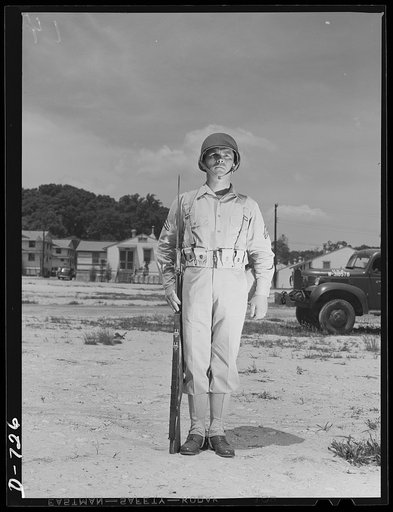 New Army helmet. Corporal French L. Vineyard, Company M, 12th Infantry, wearing a new Army helmet. Corporal Vineyard is wearing the combat pack and cartridge belt and is equipped with a Garand rifle