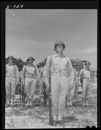 Corporal French L. Vineyard and squad standing at attention. All the men are members of Company M, 12th Infantry. Corporal Vineyard is wearing the new "pot type" of helmet. The other members of the squad are wearing the old or "basin type" of helmet. Arlington Cantonment, Arlington, Virginia