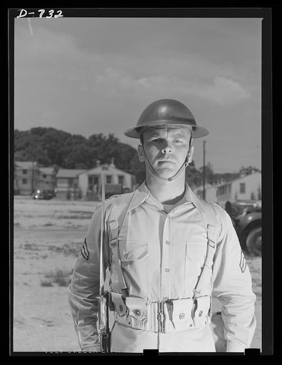 New Army helmet. Corporal French L. Vineyard, Company M, 12th Infantry. Wearing combat pack and old "basin type" helmet. Arlington Cantonment, Arlington, Virginia
