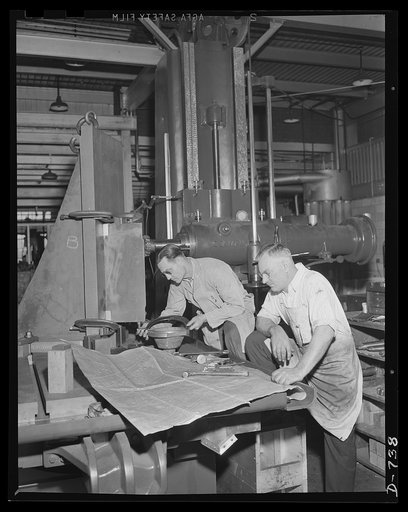 Expert machinists checking a casting which will soon be a part of a machine to make shells. Plant of Frederick Colman & Sons, Inc., Detroit, Michigan
