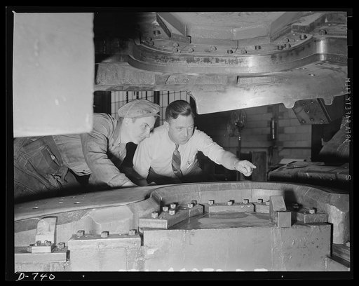 Skilled workmen checking the stock clearance on a die which will be used to trim and flange fenders. Plant of Frederick Colman & Sons, Inc., Detroit, Michigan