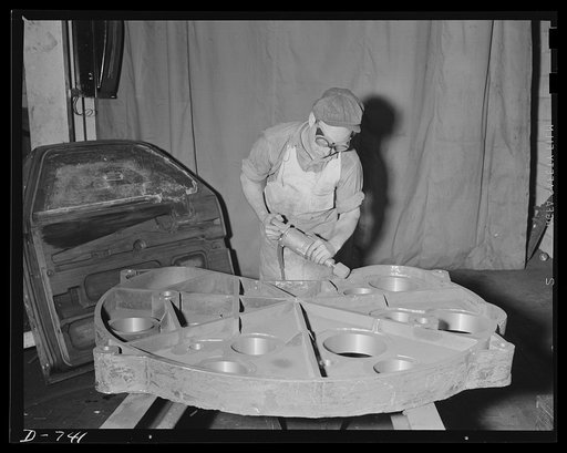 Cleaning up and burnishing an iron casting. This casting will be used as an indexing feature on a machine that will turn out airplane parts. Plant in middle west. Frederick Colman & Sons, Inc., Detroit, Michigan