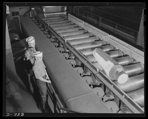 A white-hot steel ingot riding into the blooming mill. This ingot weighs about 2 1/2 tons. From it, bar and tool stock will be made. Ford River Rouge plant