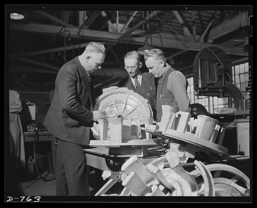 Inspection of a magnesium casting. This one is a crank case blower for an aircraft engine, and is being inspected here before being delivered to the machine shop for finishing. Ford River Rouge plant