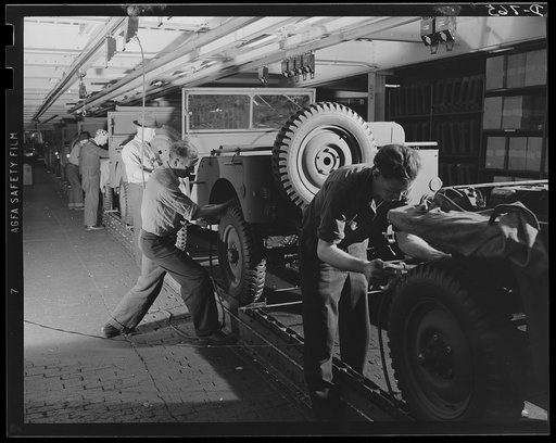 The body after being lowered, is securely fastened to the chassis and the headlights adjusted. Ford River Rouge plant
