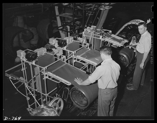 Fabric for automobile tires in the process of manufacture. The fabric here is being wrapped around a collapsible drum. Ford River Rouge plant