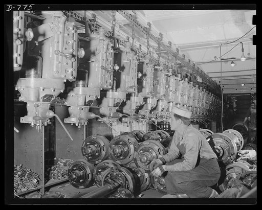 Blitz buggies. Finished motors on the conveyor line, which is taking them to the assembly point in the plant. This conveyor line is part of a conveyor system 135 miles long throughout the plant. Ford River Rouge plant