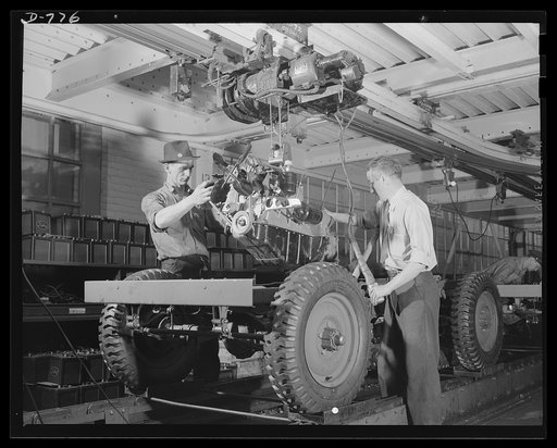 Blitz buggies. This motor has just come off the conveyor line, and is being placed in the chassis. Ford River Rouge plant