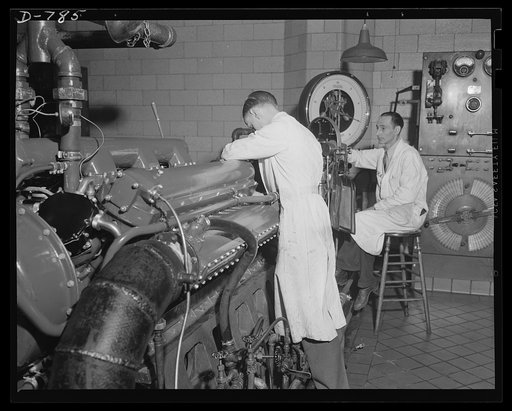 Completed marine engines being tested by engineers. The test shown here is one of the final ones to which the engine is subjected. Packard marine engine plant, Detroit