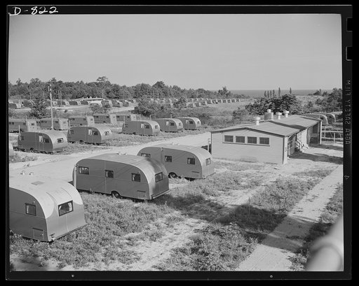 Defense housing, Erie, Pennsylvania. A central utility building (right) with toilets, showers, and laundry facilities is maintained for every sixty trailers on the site. Each trailer, with its 25 x 50 foot plot of ground, is assured of privacy and plenty of sun and fresh air. Each trailer is equippe