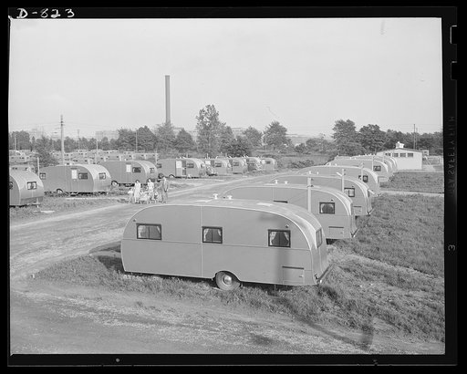 Defense housing, Erie, Pennsylvania. The spacious, open planning of the defense trailer camp affords youngsters pleant of room for playing in the sun and fresh air. In the background can be seen a smokestack of the General Electric Company, which employs some 10,000 men in defense work