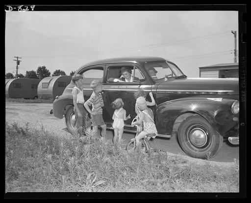 Defense housing, Erie, Pennsylvania. A member of the Visiting Nurse Association pays a call to one of many young tenants of the defense trailer camp. High standards of sanitation are maintained, and every precaution is taken to guard against epidemic and disease