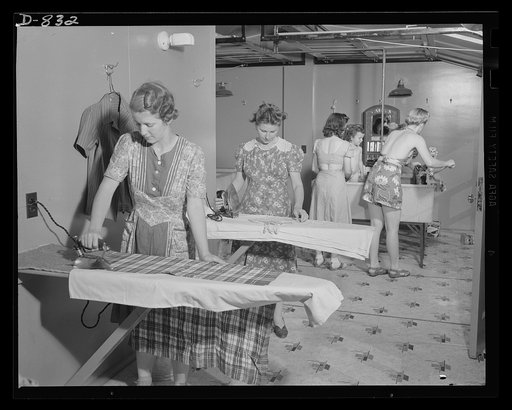 Defense housing, Erie, Pennsylvania. Interior of the laundry of one of the central utility buildings of the defense trailer camp at Erie, Pennsylvania. Complete laundry facilities, including tubs, ringers, ironing boards and drying lines are provided. Also located in the building are showers, wash b
