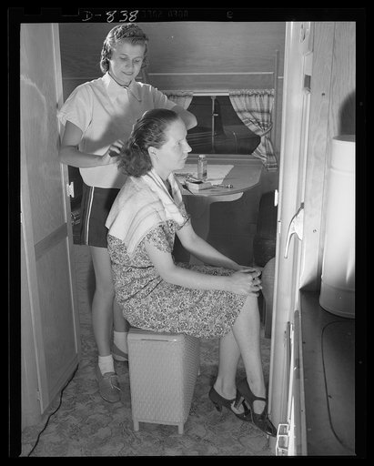 Defense housing, Erie, Pennsylvania. Mrs. Henry Colomy, Jr., is the beauty expert at the trailer camp. She does not charge for her services, and young housewives return her kindness by taking care of Mrs. Colomy's young son when she does her weekly shopping, or sometimes in the form of gifts. The hu