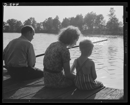 Defense housing, Erie, Pennsylvania. B.J. Rogan, one of thousands employed by the General Electric Company in Erie, Pennsylvania,to provide the nation with defense materials, enjoys a brief relaxation with his wife and small son. A beach on Lake Erie is located within a few blocks of the defense tra