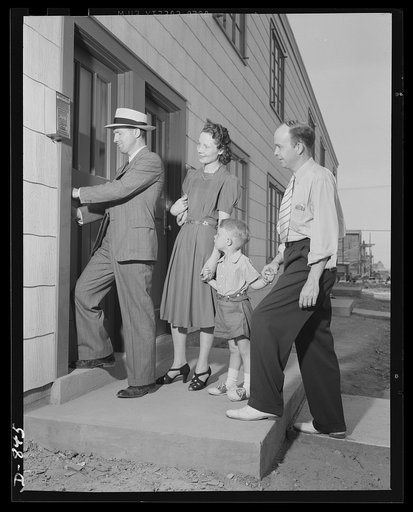 Defense housing, Erie, Pennsylvania. J.P. Kane, local defense housing manager, gives B.J. Rogan and his family a preview of their new home. 56 of the 300 defense homes now under construction in Erie, Pennsylvania had been completed when these pictures were made (July 1941). The others were scheduled