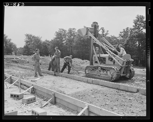 Defense housing, Erie, Pennsylvania. Leveling-off process between cement foundation blocks preparatory to receiving cinder filling. Cement floor will later be poured over with reinforcements