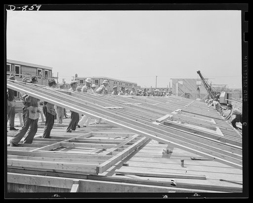 Defense housing, Erie, Pennsylvania. The entire framework, including sections for doors and windows, is fabricated horizontally. The crew working here will later move to another site and repeat the procedure. This circulation of crews who are experienced in one type of construction adds to the speed