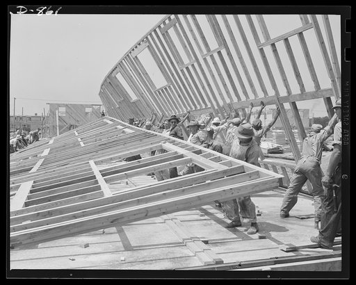 Defense housing, Erie, Pennsylvania. The entire framework, including sections for doors and windows, is fabricated horizontally. The crew working here will later move to another site and repeat the procedure. This circulation of crews who are experienced in one type of construction adds to the speed