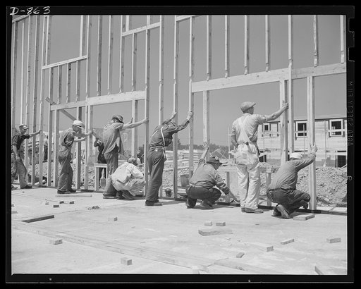 Defense housing, Erie, Pennsylvania. The entire framework, including sections for doors and windows, is fabricated horizontally. The crew working here will later move to another site and repeat the procedure. This circulation of crews who are experienced in one type of construction adds to the speed
