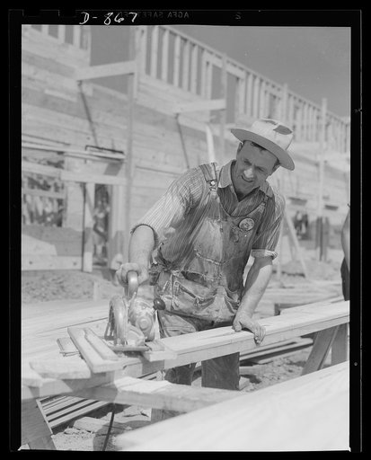 Defense housing, Erie, Pennsylvania. Cutting sheeting to size with power driven hand saws speed up the work of the sheeting crew
