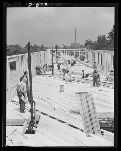 Defense housing, Erie, Pennsylvania. The sheeting-over of the second floor nears completion. Buildings of the plant where are employed many of the defense workers who will move into these homes, can be seen in the background