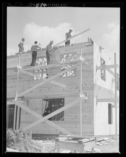 Defense housing, Erie, Pennsylvania. As the wall sheeting is completed, men are already starting the sheeting of the roof