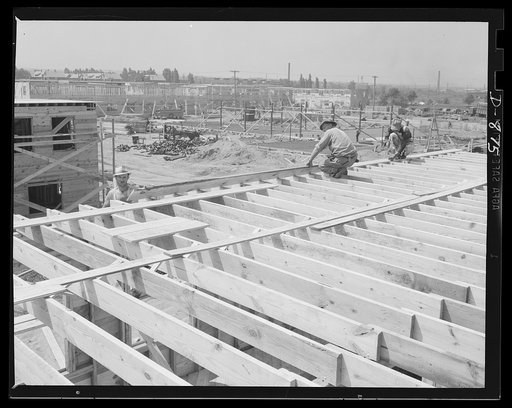 Defense housing, Erie, Pennsylvania. As the wall sheeting is completed, men are already starting the sheeting of the roof