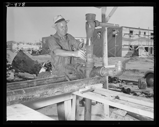 Defense housing, Erie, Pennsylvania. George Miller, plumber, is foreman of the central plumbing assembly shop. He and his helpers assemble most of the plumbing for this 300-unit defense housing project