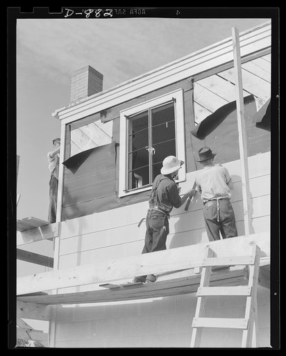 Defense housing, Erie, Pennsylvania. A shingling crew moves in. Exteriors are finished with an abestos cement composition shingle which provides insulation and weather-proofing. Shingles are secured over a tar-paper insulation with bronzed, rust resisting nails