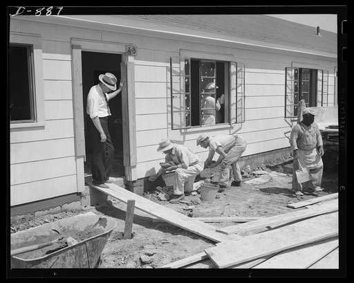 Defense housing, Erie, Pennsylvania. Richard S. Neff (standing in doorway) U.S. Housing Authority Inspector, who with his crew of five men, sees that defense homes meet up with the standards established by the Office of Emergency Management (OEM) Division of Defense Housing Co-ordination