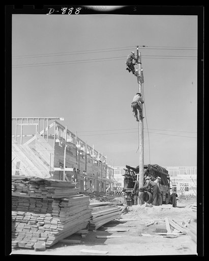 Defense housing, Erie, Pennsylvania. Electricians wiring defense homes at Franklin Terrace housing project. Defense homes are provided with electricity, sewage, police and fire protection. In many cases, a lump sum for all services is paid to the city in lieu of taxes
