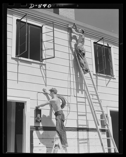 Housing, Erie, Pennsylvania. Electrician wiring defense homes at the Franklin Terrace housing project. Homes are provided with electricity, sewage, police and fire protection. In many cases, a lump sum for all services is paid to the city in lieu of taxes