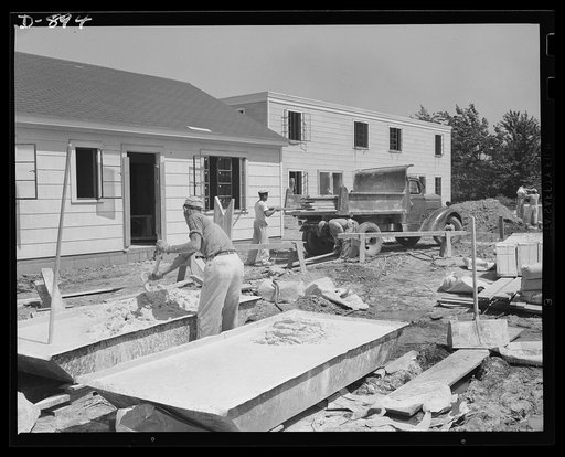Defense housing, Erie, Pennsylvania. All walls and ceilings are finished off with a good grade lime plaster. This typifies the permanent character of this defense housing construction. In this operation onlt time-honored hand craftmanship can give high quality results. Teamwork and practiced efficie