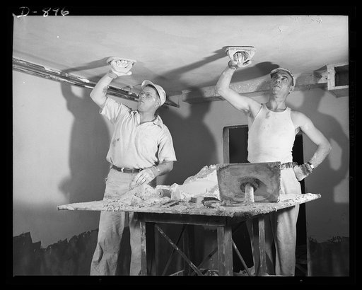 Defense housing, Erie, Pennsylvania. All walls and ceilings are finished off with a good grade lime plaster. This typifies the permanent character of this defense housing construction. In this operation onlt time-honored hand craftmanship can give high quality results. Teamwork and practiced efficie