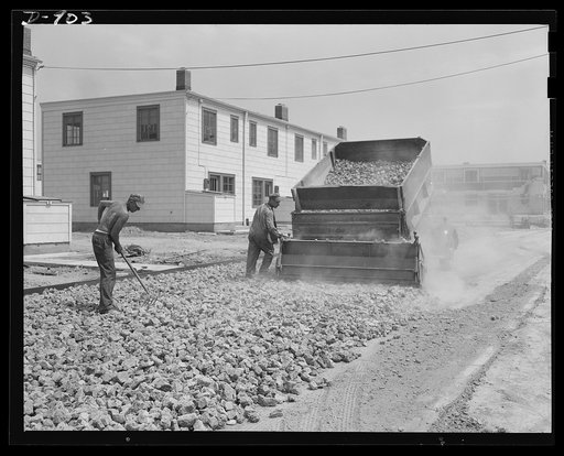 Defense housing, Erie, Pennsylvania. A good filling bed of rock-like material is laid on the graded street surface