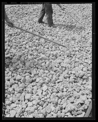 Defense housing, Erie, Pennsylvania. A good filling bed of rock-like material is laid on the graded street surface. Slag from nearby steel mills is sometimes used for this filling material