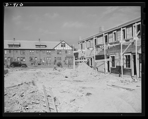 Defense housing, Erie, Pennsylvania. The old and the new. At the right is pictured one of the new defense homes now under construction, while in the background is shown one of the apartment homes built for the defense workers during World War I. Where as many of the latter homes were disposed of due