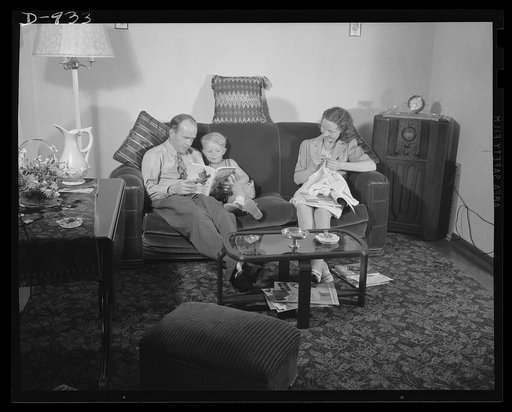 Defense housing, Erie, Pennsylvania. Mr. and Mrs. B.J. Rogan and their small son, Bernie, at home in the living room of their new defense home in Erie, Pennsylvania. Mr. Rogan is a drill press operator at the nearby General Electric Company plant. He earns $42.50 a week, and pays about twenty percen