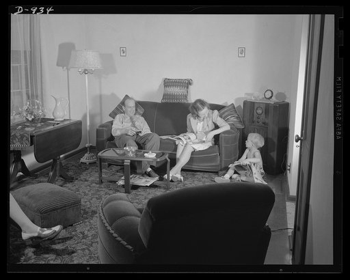 Defense housing, Erie, Pennsylvania. Mr. and Mrs. B.J. Rogan and their small son, Bernie, at home in the living room of their new defense home in Erie, Pennsylvania. Mr. Rogan is a drill press operator at the nearby General Electric Company plant. He earns $42.50 a week, and pays about twenty percen