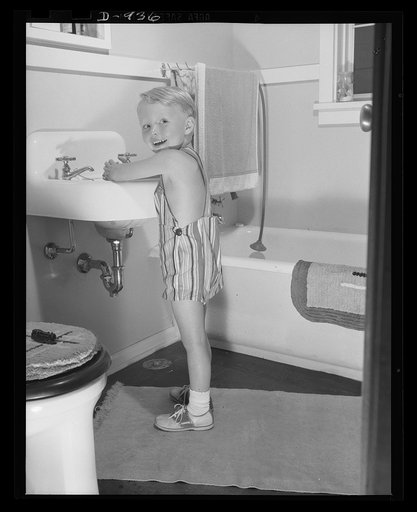 Defense housing, Erie, Pennsylvania. Bernie Rogan, son of Mr. and Mrs. B.J. Rogan, in the bathroom of the Rogan's new defense home at the Franklin Terrace housing project in Erie, Pennsylvania. His father is a drill press operator at the nearby plant of the General Electric Company, which is working