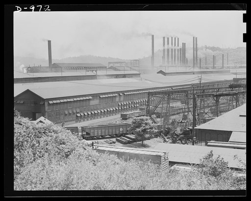 Steel alloy manufacture. Allegheny Ludlum Steel Corporation, Brackenridge, Pennsylvania. General view of part of the plant where scrap iron and steel are converted into many grades of steel alloys. In the foreground are carloads of finished products, while in the middle foreground can be seen piles 