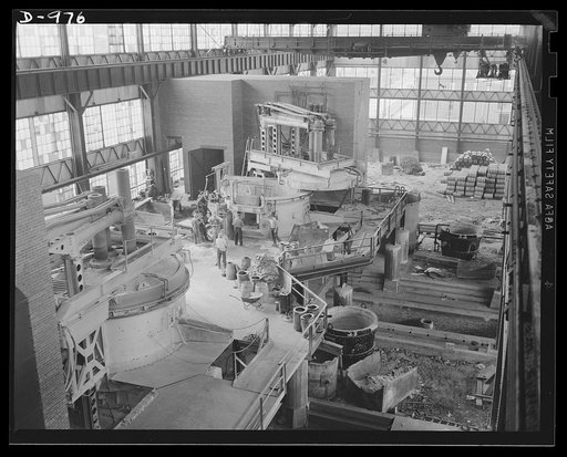 Steel alloy manufacture. Allegheny Ludlum Steel Corporation, Brackenridge, Pennsylvania. The rapid tempo of expansion necessary to meet the ever-mounting needs of the national defense production program. In the left foreground a newly completed electric melting furnace is already in operation as a c