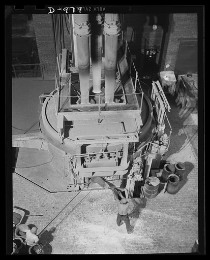 Steel alloy manufacture. Allegheny Ludlum Steel Corporation, Brackenridge, Pennsylvania. Thirty-five ton electric arc melting furnace in operation. These furnaces convert scrap iron and steel into high quality steel alloys. This type of furnace gives much faster heating and permits the accurate temp