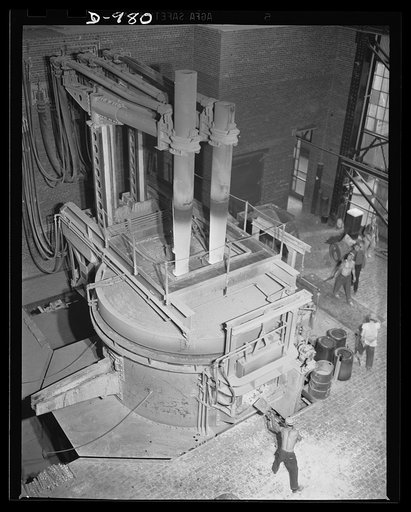 Steel alloy manufacture. Allegheny Ludlum Steel Corporation, Brackenridge, Pennsylvania. Thirty-five ton electric arc melting furnace in operation. These furnaces convert scrap iron and steel into high quality steel alloys. This type of furnace gives much faster heating and permits the accurate temp