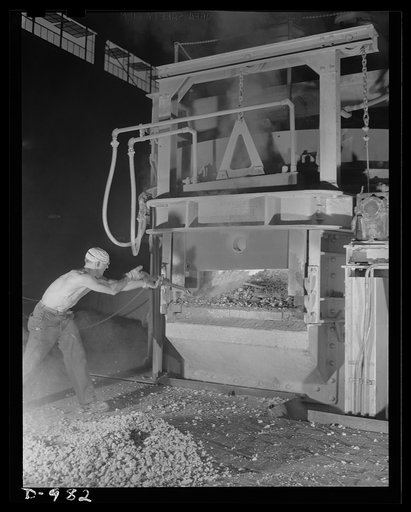 Steel alloy manufacture. Allegheny Ludlum Steel Corporation, Brackenridge, Pennsylvania. Converting scrap iron and steel into high quality alloy steel. A workman adds alloying materials to the bath of molten steel in one of the thirty-five ton electric arc furnaces. These furnaces give faster heatin