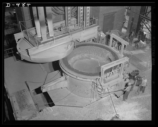 Steel alloy manufacture. Allegheny Ludlum Steel Corporation, Brackenridge, Pennsylvania. Refined alloy steel in the electric furnace, ready for casting into ingots. The slag layer on top of the molten steel prevents the hot steel from oxidizing, thereby preserving its high quality. This is an operat