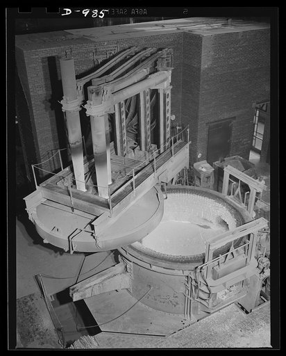 Steel alloy manufacture. Allegheny Ludlum Steel Corporation, Brackenridge, Pennsylvania. Refined alloy steel in the electric furnace, ready for casting into ingots. The slag layer on top of the molten steel prevents the hot steel from oxidizing, thereby preserving its high quality. Steel will be dra